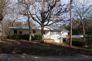 Sitting on two lots near the fisherman friendly waters of Bull Shoals Lake this 3bed 2bath home has a nice deck off of the master bedroom to enjoy your morning coffee, a bonus room that can be a 4th bedroom or family room, storage building, a nice detached carport for your boat, unfinished basement with tons of room for a workshop or storage and so much more.