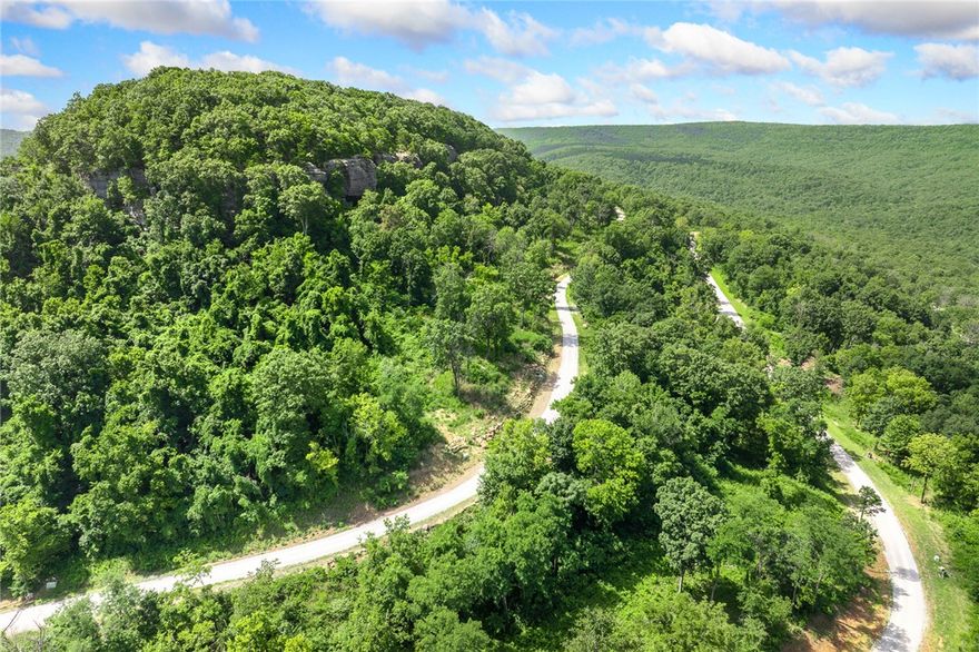 The groundwork is already done for you!  This lot comes fully equipped with underground utilities already in place, including natural gas, fiber optic internet, electric, public water, and sewer. No waiting, no guesswork, no costly setup—just a smooth, ready-to-build opportunity from day one.  Lot 119 (1.30 m/l ac) of Round Mountain Estates offers a bluff line to the east, unique rock formations and like most lots on Significance Summit, room on the downhill side so you can create views that go for miles and miles!  RME is the newest subdivision in Harrison, AR. If you’ve been dreaming of trading city lights for star-filled skies, RME delivers. Beyond your homesite, you’ll have access to a 350 acre common area reserved for residents, featuring a stocked fishing pond, Kissing Rock Trail, natural springs, Baby Canyon Trail, striking bluff lines and views that stretch for miles.  *Terrapin Creek Rd will be paved in the future, per county officials.
