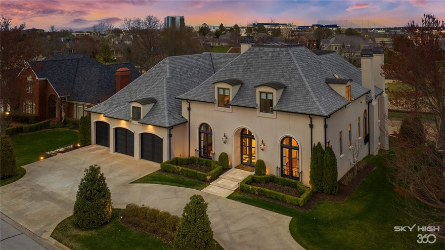 Located in Pinnacle Country Club this golf course lot has breathtaking panoramic views of holes 13 & 14. This exquisite custom home was built to perfection sparing no expense. Details such as calcatta quartz and carrara marble countertops, Sub-Zero & Wolf appliances, museum quality finished walls, white oak premium hardwoods, designer lighting and hardware, walls of French doors, custom millwork, dome and barrel ceilings, 5 fireplaces, and a simply stunning all marble master bath with freestanding tub and luxurious walk-in closets. Featuring 2 bedrooms on the main level of the home with 2 more on-suite bedrooms (and additional washer/dryer) on the second level. Basement level is an entertainer's dream with walk-out recreation room and wet bar, billiard’s/exercise room, safe room, theater room and abundant storage. The limestone terrace has a grilling kitchen, stone arbor and elevated saltwater fitness pool with 2 fountains overlooking the golf course.