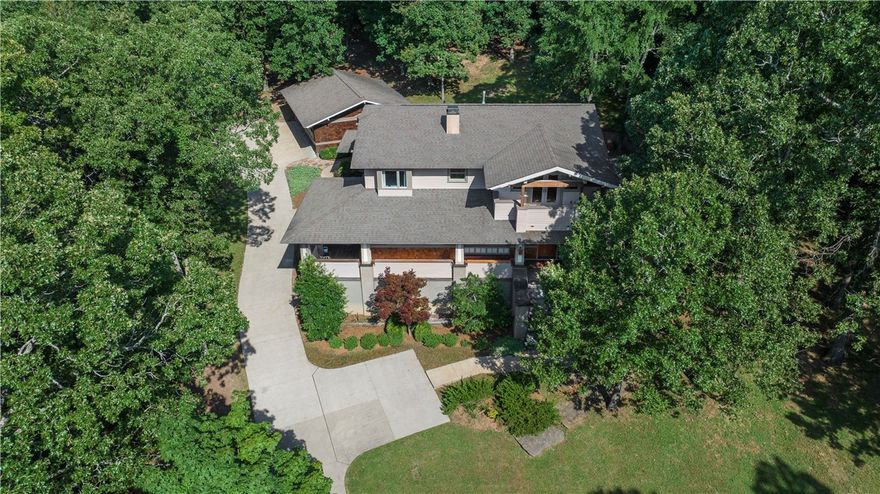 Enjoy peaceful living on an exclusive private drive on Mt. Sequoyah in a custom cedar craftsman by DEMX Architects. Access to Sequoyah Preserve and minutes to downtown. Entertain with an unparalleled layout with hickory hardwood floors, endless storage in maple and walnut cabinetry and teak decks. Chef's kitchen, butler’s pantry and walk-in pantry. Living room features wet bar with roll-out bar and gas fireplace. Dining room shares dual sided fireplace with library. Secluded fieldstone patio and gas fire pit in back. Primary suite has dual oversized walk-in closets, large luxurious jetted tub, and glass walk-in shower with dual shower heads. Upstairs, enjoy another living room, 3 bedrooms w/ walk-in closets, 2 full bathrooms and teak balcony with seasonal views. Whole home humidity control, efficient fresh air ventilators: ERVs. New heat pump water heater with instant backups. Up and downstairs laundry. Temp and humidity-controlled garage easily fits XL vehicles: +/-875 sqft not in listing.