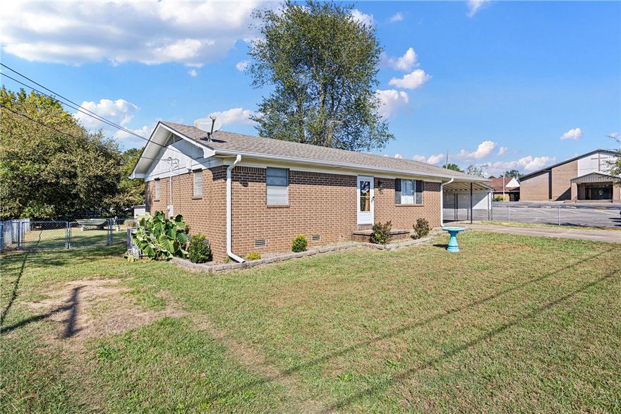 This home is centrally located, close to the downtown shopping district, yet the park-like backyard makes it seem secluded. This cozy 2-bedroom, one-bath home has been updated with new HVAC, DISHWASHER, GUTTERS, FLOORING IN BEDROOMS, and CEILING FANS.
Sit on the covered back deck and enjoy the cool mornings or evenings. There is a fire ring for roasting hot dogs and making s'mores! The back yard is chain-fenced in, as well as a large storage building to store your treasures. There are many other updates but must see in person to appreciate it.