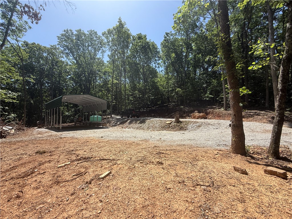 This is the spot to be! Private unrestiricted nearly 8 acres, developed with all utilities, AND private access to shared 22 acres of White River Access. Located in the mountain community of River Meadows. Move your camper right into the 20x30x12 awning that has cement footings and all of your utiltiy hookups. The septiic is professionally installed and less than 1 year old. It has two hooks ups ready and three additional options for expansion. There is a water tank on site and ready to be plumbed into your camper/cabin. Fiber is availble at the site by Ozark Go. 200amp power is run to the awning with 100 amp servicing a 30 amp outlet, over head lighting, and several ground fault outlets. There has been extensive ground work to create roads and mulitiple building pads/parking areas. The property has a cave, waterfall, and seasonal creek that runs most of the year. Deer, bear, and turkeys are often on the property. Just a short drive down M5114 you can access the private 22 acres to swim, kayak, or trail ride.