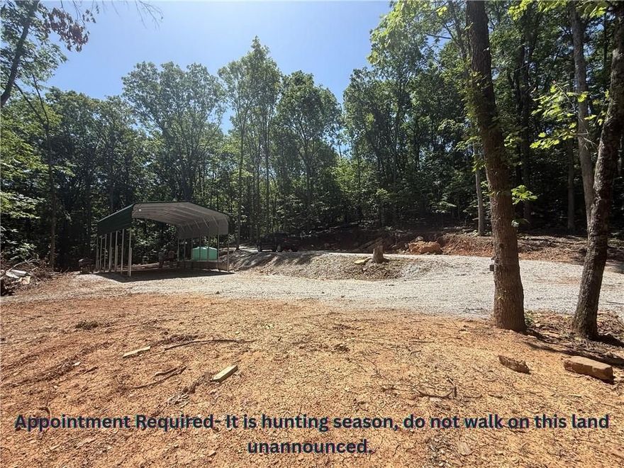 This is the spot to be! - Apt Required- unrestricted nearly 8 acres, developed with all utilities, AND private access to shared 22 acres of White River Access. Located in the mountain community of River Meadows. Move your camper right into the 20x30x12 awning that has cement footings and all of your utiltiy hookups. The septic is professionally installed and less than 1 year old. It has two hooks ups ready and three additional options for expansion. There is a water tank on site and ready to be plumbed into your camper/cabin. Fiber is available at the site by Ozark Go. 200amp power is run to the awning with 100 amp servicing a 30 amp outlet, over head lighting, and several ground fault outlets. There has been extensive ground work to create roads and mulitiple building pads/parking areas. The property has a cave, waterfall, and seasonal creek that runs most of the year. Deer, bear, and turkeys are often on the property. Just a short drive down M5114 you can access the private 22 acres to swim, kayak, or trail ride.