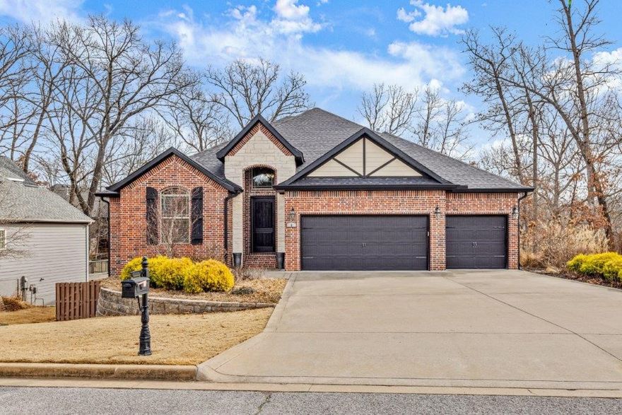 Gorgeous Woods Creek Home w/all the space you need in sought after location, quick access to I-49, Downtown Bentonville & Multiple Trails. Cul-de-sac location & 3 car garage. Spacious living areas featuring hardwood floors throughout. Guest bedroom off entry w/access to full bath. Large living room w/gas fireplace. Kitchen w/spacious counter seating, island, abundant counter & cabinet space, large hidden pantry, gas range, built in double ovens & prep sink. Covered deck is a great space to enjoy your wooded setting. Primary suite w/attached bath featuring whirlpool tub & large shower, the WIC has access to laundry. Downstairs is a massive bonus space w/wet bar, hardwood floors, and access to the lower covered patio with tv hookups and hot tub! 4 guest bedrooms on lower level and a large guest bath with double vanity offer plenty of space either for guests, office, exercise, or whatever you need! The large fenced backyard has an outdoor firepit and lots of space for outdoor living. This home is a MUST SEE!