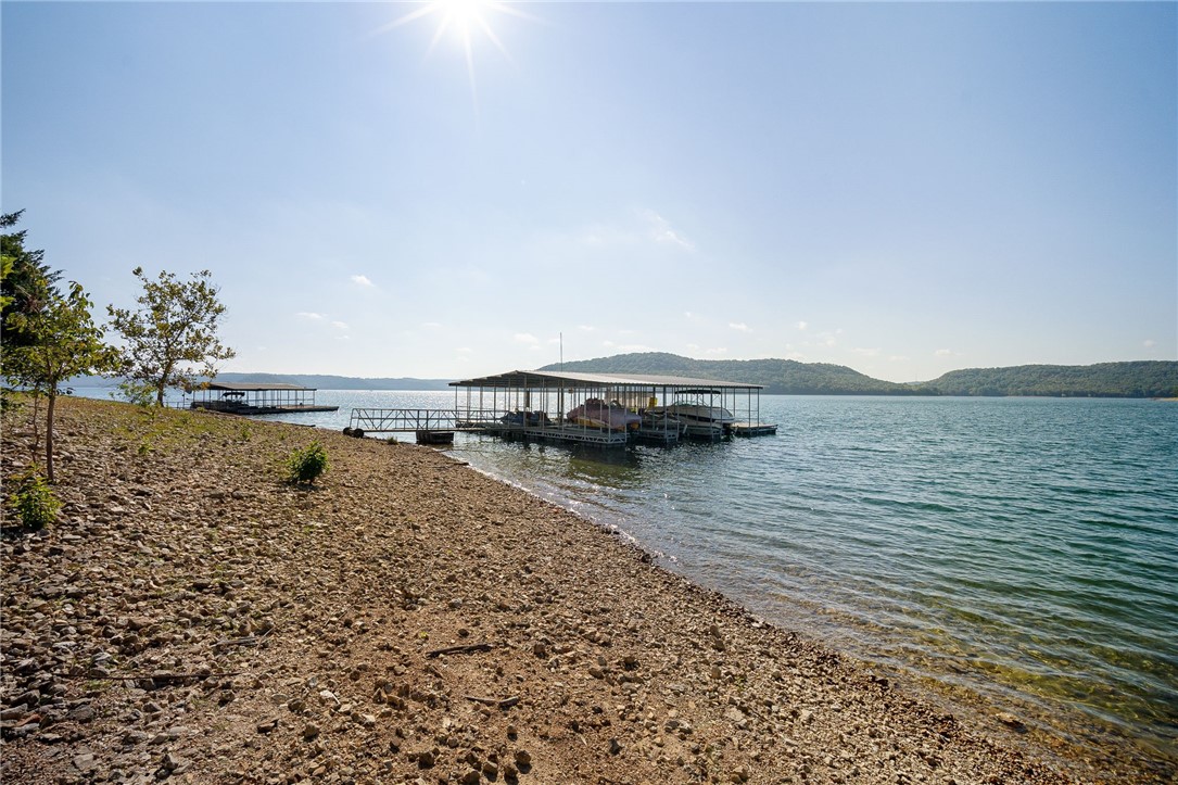 Boat Slip Alert! Walk or quick ride down to your private boat slip, with a boat lift and an amazing view. Also nearby boat ramp-access. This home makes a great retreat for entertaining as well, featuring identical layout upstairs and down, on a double lot. Large windows and deck to take in the natural light and beautiful surroundings. Both floors also have their own washer / dryer hookups making it even better for extra company. Open kitchen features a double-oven and JennAir interchangeable cooktop. Well-built home with extra roof joists and extra insulation. Backyard has a fenced-in area for pets too! See attached video of this beautiful setting. You've been looking, now here it is!