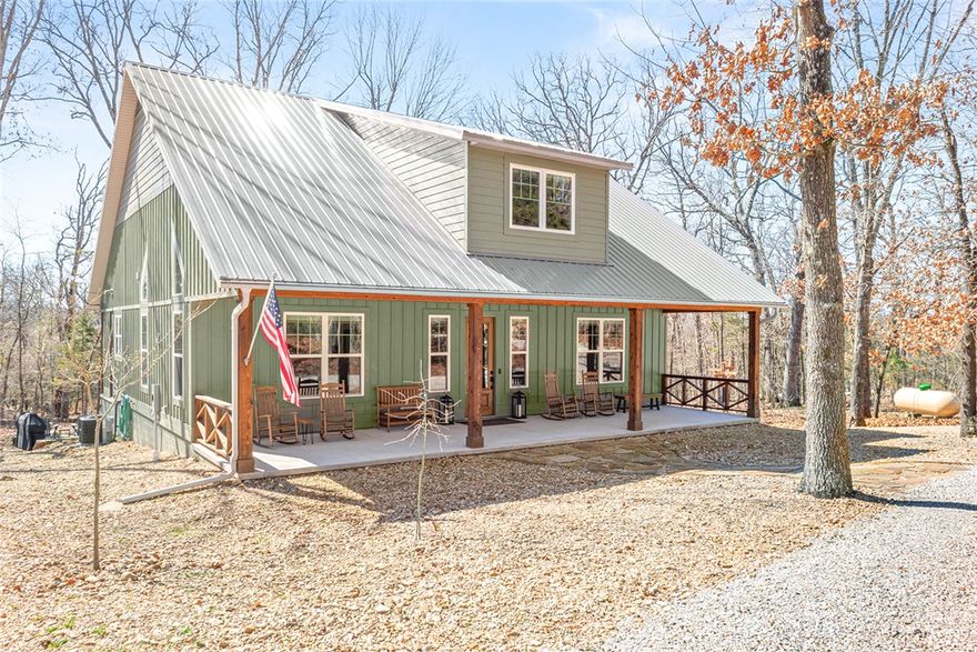 Retreat to this meticulously maintained, custom home on Beaver Lake, nestled on 4 private, wooded acres with seasonal lake views. Designed for those who value craftsmanship & peace, every detail is intentional, from high-end finishes & white oak hardwood floors to expansive windows framing natural surroundings. Enjoy indoor-outdoor living on two 10x44' porches, one screened, & native stone patio w/hot tub & fire pit. Inside, a stunning great room features 20-foot Texas Limestone fireplace & pine beams. A chef’s kitchen boasts custom island, quartz counters, stainless steel appliances, farmhouse sink, & walk-in pantry. Primary suite is a quiet sanctuary w/soaring ceilings, pine beams, & spa-like bath w/a soaking tub & walk-in shower. Upstairs offers 2 large bedrooms w/en-suite baths & versatile bonus space. Hobbyists will love the two detached, 2-car garages, one w/workshop. Located a short drive from Rocky Branch Marina & Hobbs State Park, this legacy property offers a lifestyle of quiet luxury & outdoor adventure!