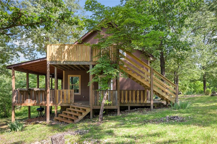 This cabin has a private setting with 4 bedrooms and 3 bathrooms plus almost 6 acres mostly fenced. Includes a nice outbuilding.  Just a few minutes away from Tomahawk Creek and Approx 2-3miles from Buffalo River and Gilbert. The wrap around deck and loft deck is perfect for enjoying outdoor wildlife. Perfect outdoor living if you enjoy fishing, canoeing and swimming! More pictures coming soon