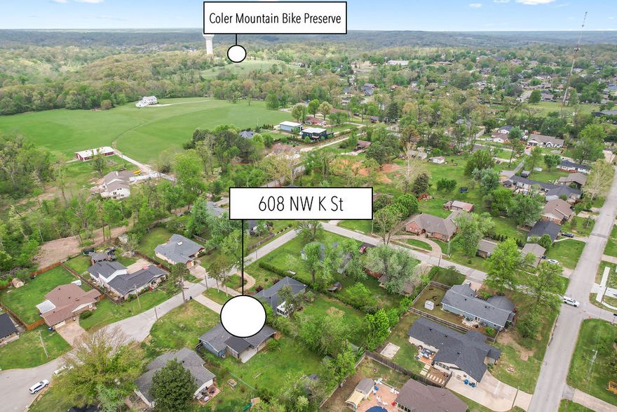 Welcome to 608 NW K St, a move-in ready home in the heart of one of the country’s most sought-after biking destinations. This 1,796 sq ft home was thoughtfully renovated in 2017, offering comfortable living with modern updates throughout. What truly sets this property apart is the custom built 10x30 bike shop added in 2020. The space features insulated walls, perfect for a dedicated bike studio, workshop, storage, or even a work-from-home setup. Whether you're tuning gear, storing bikes, or creating your own indoor training space, this setup is built for the cycling lifestyle.
The home has been well maintained, with ductwork professionally cleaned in 2025, an HVAC inspection and tune up completed in 2025, and new gutters installed in 2023. Located just minutes from Coler Preserve, the home also offers convenient access to the Greenway, connecting you to Bentonville’s extensive trail network and world-class mountain biking and gravel routes throughout Bentonville and Bella Vista.