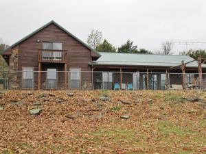 Beautiful secluded Compton home and 10 acres with a barn located on a ridge road above Osage Creek. Features a pristine 20x40 pool, huge living area with a nice wood heating stove to make a cozy living area when you want the cozy sound of a fire. It has two master suites with jacuzzi style tubs, lofted sleeping area plus 2 bedrooms and guest bath. Large kitchen and dining. All electric, central heat and air with almost new (3 yr) energy efficient heat pump. The upstairs Master Suite was added in 2002 and has a balcony overlooking the pool. New roof in 2012. Only pre-qualified buyers may view the house.