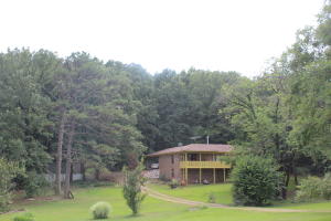 WHAT A VIEW FROM YOUR BALCONY! This home sits on 13 acres with a perfect mixture of open and wooded land. There is a nice sized pond, a balcony to take in the view, and a nice workshop. On the inside, you'll find a spacious kitchen and living room area. There is a nice wood burning stove and plenty of storage space. There is an unfinished full sized walk out basement. This house is just minutes from town with lots of privacy. Don't miss the chance to see this one in person. Call today.