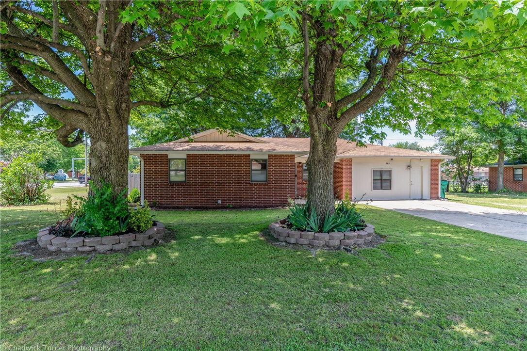 This 1969 1-Story, 3-Bedrooms, 1.5-Baths, 1,869sqft brick home with partially fenced backyard, garage was converted to family room and work bench storage areas. Some updates throughout make this home move-in ready condition. Eat-in kitchen w/some extra cabinets & counter space, some appliances convey, laundry area has extra shelving for storage white fridge conveys, black fridge in kitchen does not convey, enclosed sunroom/back porch, pellet stove in family room, pergola and patio area in backyard, shed conveys too, you still have room to keep your RV or Camper parked or stored on the side or build extra garage on the right side of house, lower maintenance home w/easy access to Elm Springs Rd near I-49, good starter home or investment rental.
