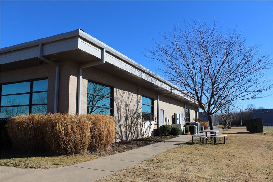 Fully furnished 9,706 SF office space. Conveniently located to Wal-Mart and Sam’s Club Home Offices,  close to NorthWest Arkansas Community College and I-49.  This turnkey office opportunity has two reception areas, two break rooms, multiple private offices, conference rooms and cubicle workstations ready for immediate occupancy.  Can be single tenant or easily subdivided into two suites.  Great location for a vendor, CPA, attorney, engineer, architect or a company that needs office and showroom space.