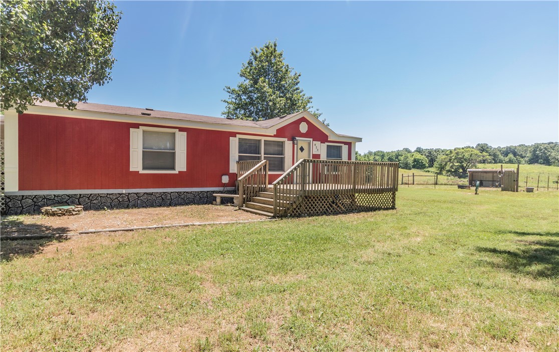 Have big ideas for farming or gardening? Look no further! This beautiful homestead features 5 gently rolling acres, a remarkable transformation of the 3bed 2bath mobile home, AND a 1,200sqft shop. Every inch of the inside has been completely remodeled. New flooring, fresh paint all throughout, new countertops and backsplash in kitchen. Lots of space to create and make this property into just what you need. Refrigerator, washer, and dryer do convey with home. 2-10 Home Buyer Warranty included. Within walking distance is the community pool, and park. Very close to the library, Dollar General, and a short drive to Centerton or Gentry for other amenities. Don't miss this great opportunity!