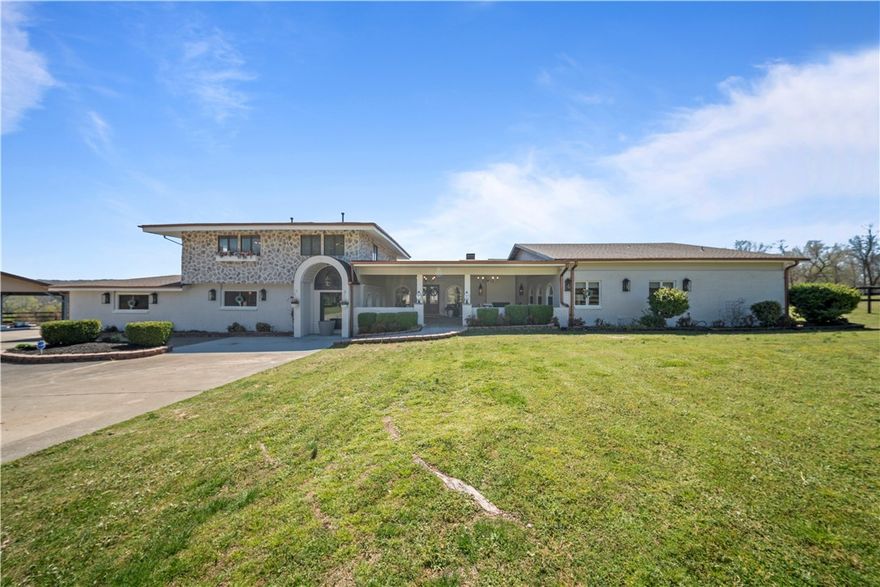 Beautifully remodeled estate on 3 acres in one of NWA’s most scenic areas, just minutes from The Blessings golf course. A tree-lined gated driveway leads to this exceptional property welcoming you with a large front porch that has a seating area and fireplace. The home features 6 bedrooms and 5.5 bathrooms, 4 of them ensuites. Thoughtful design detail throughout the home makes it unique and inviting. The primary suite has its own fireplace and separate his/hers closets. The chef’s kitchen features a double oven, an induction cooktop, and a 12' solid wood island as well as an accordion door that opens to the pool & pergola-covered patio, ideal for entertaining. Additional spaces include an office and movie room. A separate 650sqft family room features a dry bar & 120" projector screen. Solar panels decrease your electric bill drastically. The property feels private and secluded while still convenient - just 5 min to Hwy 112, 7 min to I-49, & less than 30 mins to the Walmart Home Office. Additional acreage available.