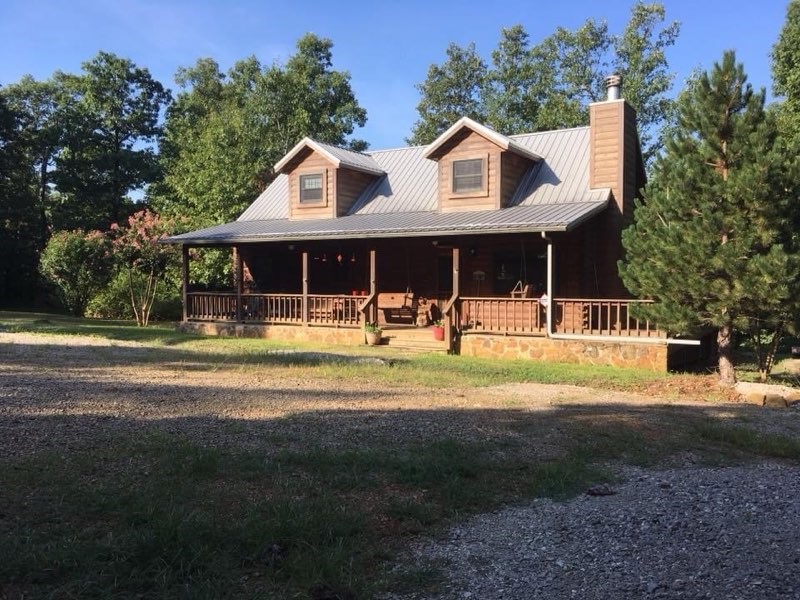 Beautiful Cypress log cabin, 1500sf 3 Bedrooms, 2 Baths, native-stone wood burning fireplace, 2 covered porches, 2 car garage with concrete floor, end of the road for ultimate privacy, stocked pond. Located close to the Buffalo National River at Steel Creek access point for kayaking, hiking and Elk watching. Secluded log home off Highway 74, up from Low Gap , 483 NC 8060. 8” D log home , dove tail corners, high end cypress logs. Logs maintained with stain/treatments for interior/exterior. 15.93 acres, meadows, stocked pond. Home in the beauty of nature or for smart investment. Red buds, dogwoods, persimmons, forsythias. Berry vines. 8 varieties large trees.
Log home, 1500 sq. ft, built in 2003, maintained well. 2 br, 3rd br in large loft, 2 full bathrooms, washer, dryer, refrigerator, gas range . Sunny main room has French doors opening to back porch with view of Boxley Valley and Arkansas sunsets. Stone fireplace, WiFi/land line available. Large covered front/back porches, connecting side porch.Stone fire pit.