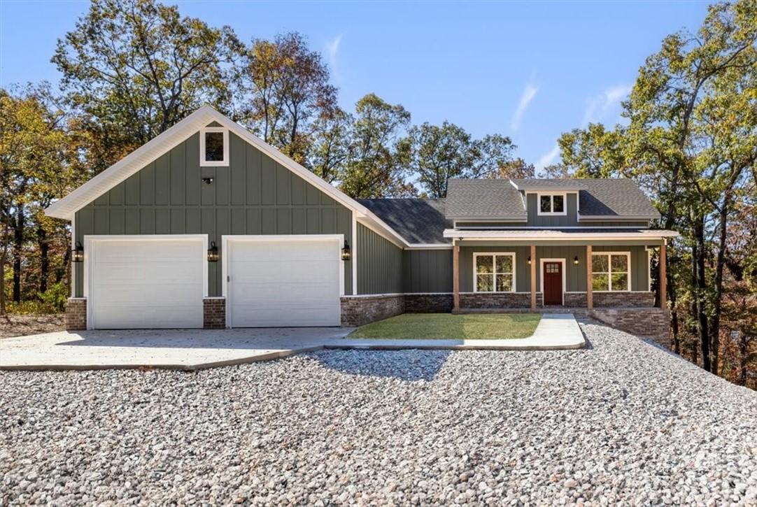 Beautiful NEW lake home for sale on Beaver Lake with 1.68 acres. Most of the land goes all the way to the water. No dock, but gorgeous view. Sits right on the horseshoe at Beaver Lake. Custom built - 2,026 sq. ft., open floor plan, 3 bedroom, 2 bath. This home has custom cabinets, double ovens, dishwasher, microwave and oversized island in kitchen for great family time. 2 fireplaces - 1 in the living area and 1 on the screened in porch to snuggle up in front of on a cool evening while enjoying the year round lake view. All wheelchair accessible with large walk-in closet in master suite. Cast iron soaking tub by large window in master suite bath with lake views for relaxation. Also has 6x8 safe room accessible from inside the oversized 2 car garage. There is also an ATV storage under the back of the home with lots of additional storage that is accessible through the home or a garage door. Home has also been wired for Generic Generator. Home would be a great investment for a Airbnb.
