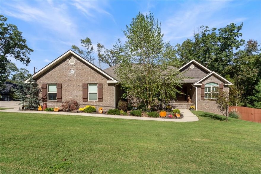 Built in 2020, this stunning 2,392 SF, 3 bedroom, 2 bath brick home offers thoughtful design, abundant storage and elegant details throughout. Situated on a beautifully landscaped .35 acre corner lot, you'll step into a large foyer that opens into a welcoming living room with wood flooring and a cozy gas log fireplace. The formal dining room is generously sized, with room for an office area. The chef's kitchen is a dream with a large island, an abundance of cabinetry, pantry, wall oven and electric cooktop. A bright eat in area completes the space. The split floorplan offers a large primary suite with a fully tiled shower, whirlpool tub and large walk-in closet with built in dresser. Laundry room with sink and cabinetry. Workshop space w/ extra storage in lower level with spray foam insulation. Attic storage. 2024 8x12 storage building. Oversized 3 car garage w/epoxy flooring. Fenced yard. Washer, dryer, refrigerator and hot tub negotiable. Bentonville schools!  A meticulously maintained, beautiful home!