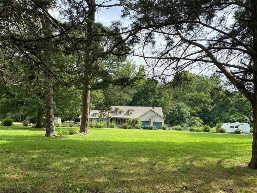 Beautiful landscaping, not far from town but you get your own privacy in the woods. New roof 10 year warranty, brick and vinyl, double pane windows, 12" outside walls to complete the landscaping.