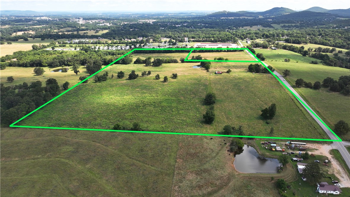 INVESTMENT OPPORTUNITY! - 60 ACRES, 10 in city limits and 50 outside city limits ready to develop. Land has Highway 21 Frontage and is mostly flat and cleared. Would make an ideal location for a new sub-division or great place to build your dream home with livestock and land to roam just minutes from downtown Berryville with all the amenities and just touching the city limits. Property has a pond and currently, has lots of pasture.
