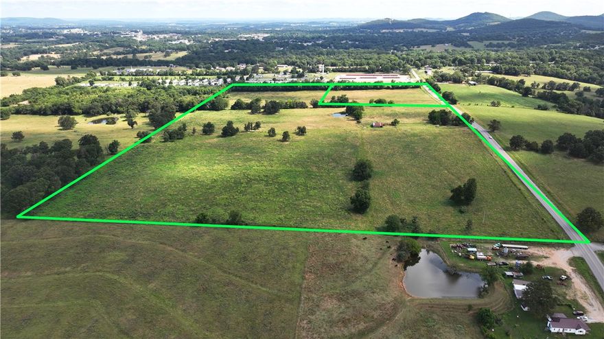 INVESTMENT OPPORTUNITY! - 60 ACRES, 10 in city limits and 50 outside city limits ready to develop.  Land has Highway 21 Frontage and is mostly flat and cleared.  Would make an ideal location for a new sub-division or great place to build your dream home with livestock and land to roam just minutes from downtown Berryville with all the amenities and just touching the city limits. Property has a pond and currently, has lots of pasture.