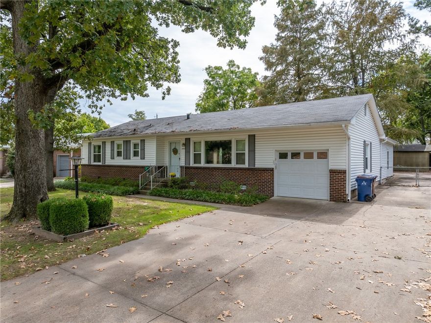 Charming and well-maintained, this home offers great potential with original hardwood floors preserved under the carpet, ready to be restored. The property boasts a newer HVAC system and features a large utility room off the garage, complete with a washer, dryer, and extra refrigerator that will stay. This versatile space can also be utilized as a workshop or for additional storage.Currently configured as a two-bedroom, two-bath home, it offers the flexibility to be converted into a three-bedroom by transforming one of the two living spaces. The home also includes newer windows and a dining room for family meals.The expansive backyard is perfect for outdoor living, complete with a covered porch, a greenhouse with electricity, a storage building, and a built-in smoker. Conveniently located in a desirable area of Fort Smith, this property is a fantastic opportunity to do a little updating & make it your own.