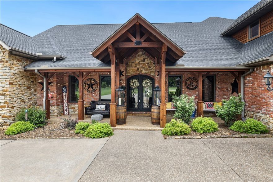 Escape to a dream retreat in Bentonville with this exceptional property offering 7388 square feet of luxury living space. Nestled amidst a park-like setting and with a stunning view, this estate provides a peaceful atmosphere, just 5 minutes from downtown. The main home features 5 bedrooms and 5.5 bathrooms, including a luxurious primary suite. The knotty pine cabinetry and wood trim throughout exude a cozy mountain getaway feel. Outside, enjoy the resort-style setting with a pool, hot tub, and a grotto waterfall with slide. The outdoor kitchen and speakers create the perfect entertainment space. Close access to biking trails and a par 3 target green. The guest house offers the same amenities as the main home. Every bedroom in both houses has an en suite bathroom. Live a vacation lifestyle every day!