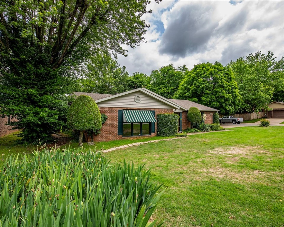 Check this one out - an absolutely wonderful 3 BR, 2 BA brick home located on a quiet and cozy back street close to everything in north Fayetteville! This home is in very good shape and has been well taken care of by the same owner for over 25 years. Lots of upgrades and improvements, an 18x20 2-car carport within the privacy fenced backyard along with an 8x16 storage shed, a concrete patio with a pergola, new roof in 2020, new insulated garage door in 2021, new kitchen range and dishwasher in 2024. Fantastic location! WRMC is within 2 blocks, I-49 only 3 minutes away, 5 minutes to the UofA. Added extra - Refrigerator, washer and dryer convey to buyer!