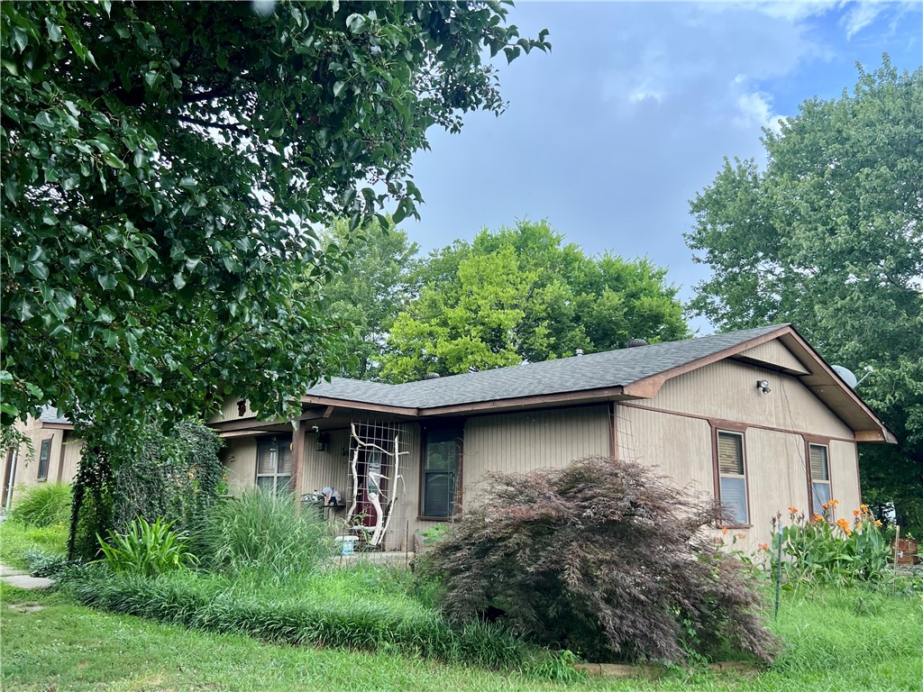 Opportunity awaits! Charming home with good bones and large shop on .55 acres with Hwy 16 frontage and only 4 miles from I49. Whether you are an investor, DIY enthusiast or looking for a diamond in the rough, this property offers incredible potential and value. The home features a cozy layout, mature landscaping, generous yard, perfect for gardening, entertaining or future expansion. What truly sets this property apart is the location and the massive 36x50 detached shop with electric, separate office space with entrance, 2 rollup doors and 12 ft side walls. Ideal for hobbyists, small business owners or additional storage. The home does need some TLC, making it a perfect canvas for your personal touch or renovation vision. Don't miss your chance to own this unique property with both residential and workshop space.
