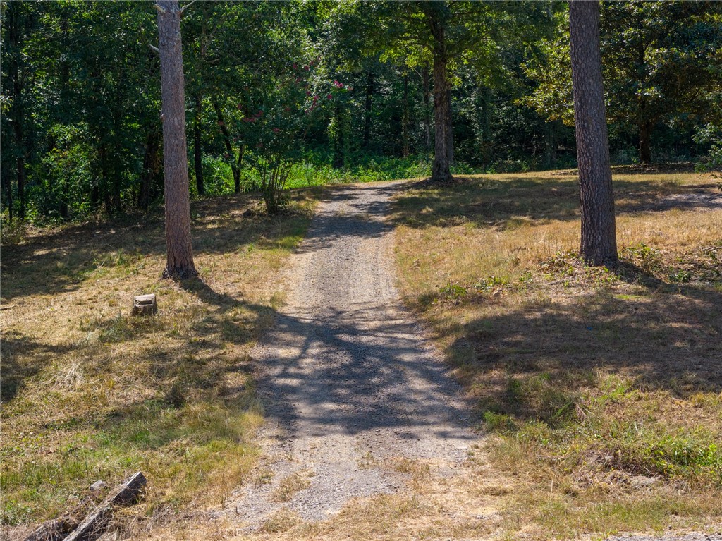 All utilities are in place, making this 1.7-acre property ready for your home, RV, or tiny house. Features include a greenhouse with electricity, chicken coop, and a 50-amp RV plugāperfect for temporary or full-time stays. Flat areas offer multiple building sites, and septic is already installed. Enjoy the beauty of a blooming magnolia tree, frequent deer and wildlife sightings, and the peace of your own private retreat. Endless potential to build, homestead, or create the getaway youāve always wanted!