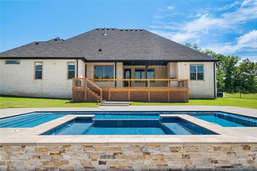 Discover the epitome of luxury living & natural beauty in this exquisite home with a private pool + hot tub on a 1+ acre lot. The enchanting Healing Springs neighborhood is flanked by a serene 84+ acre conservational wilderness area with a pond, waterfall & springs, offering a tranquil retreat for nature enthusiasts. When you walk into the living room, you will be greeted by vaulted ceilings & large windows overlooking the pool & treelined backyard. The primary bedroom suite flows through to the spacious laundry room on the main level. A dedicated office, formal dining room, eat-in-kitchen, half-bath & 2 other bedroom/bathroom ensuites can also be found on the main level. The oversized 3-car garage has plenty of room for a workshop. Upstairs, you will find a bonus room, 1 more bedroom, a full bath & ample attic storage. The backyard offers an oversized deck, rod iron fencing, a heated private saltwater pool & hot tub. Central location to NWA.