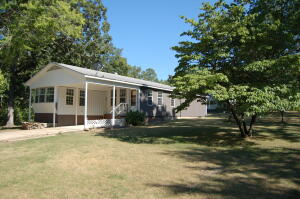 Nestled on 3 lots in the Bull Shoals Lake community of Diamond City this 3bed 2bath mobile with stick built addition has been completely remodeled and ready to go. interior boasts new flooring, new 3 ton energy efficient mini split heat and air system, great open floor plan with plenty of storage and so much more! on the exterior you can enjoy your morning coffee on the covered deck! Just a short drive to Sugarloaf Harbor Marina and 18 hole championship golf course. All numbers are approximate and are per Boone county records.