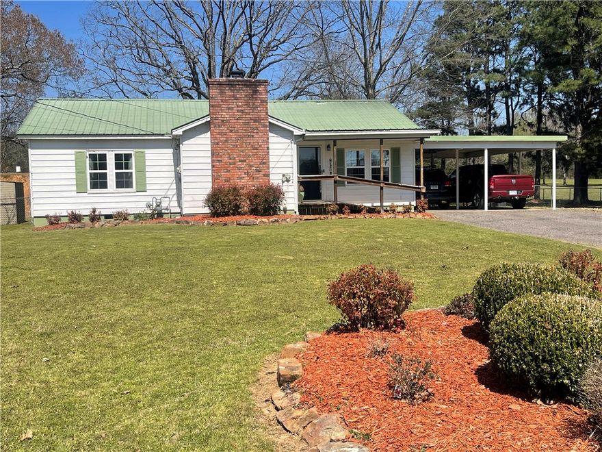 Picture postcard perfect! Quiet country home offers a gentle, well manicured, park-like setting in city limits yet hosts the country vibe. The home itself is charming with a  large, covered deck off the back. Surrounded by pastures, ponds, and horses, you can enjoy the evening sunsets. Bedrooms are spacious and have plenty of closet storage. Gorgeous landscaping on the lovely lawn plus mature fruit and shade trees. Raised garden beds convey. Check out the "above ground" storage shelter with electricity and loads of space. The large shop has an office that is heated and cooled. Great space for tinkering, hobbies, etc. This listing is a place defined not by stuffy grandeur, but by space, calm, and a deep sense of connection to the country. PREQUALIFIED BUYERS ONLY.