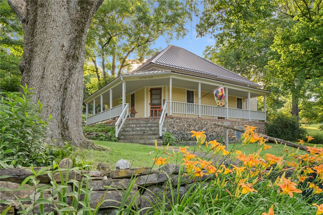 This completely restored, mostly furnished, 1920's farmhouse is nothing shy of picture perfect! From the moment you drive up to the property, you can see why this one is special and one of a kind. The main house features 2 bedrooms, 1 full bathroom, new roof, new electrical, new plumbing, original hard wood flooring and door knobs, custom wood cabinets in the kitchen, stainless appliances (besides the fridge), a farmhouse sink and lovely covered front and back porches. There is 2.0 m/l acres with no restrictions, 7 miles to the Buffalo National River and just 0.20 miles down a nice county maintained dirt road. The Bunkhouse is mostly complete with heat and air, metal roof and just needs flooring to be complete...plus, a new outhouse! There are several indigenous large outcroppings, black walnut trees, perennials, flowering shrubs and bushes and a separate workshop to boot! Whether you want to make this your new home, an investment property or a vacation home, you will be the lucky one if you're the next owner!