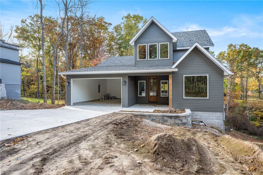 Stunning new-construction home on a large .40 lot, with 2,066 sq ft on two levels. Real hardwood floors with matte-finish throughout home! Open floor plan, with stylish finishes. The oversized kitchen features white quartz counters, black composite farm sink with commercial-style matte black faucet, GE stainless appliances including refrigerator, and a huge walk-in pantry. Enjoy wooded backyard views from the large picture window. Home offers 4 bedrooms plus an office (septic rated for 3 bedrooms). Designer tile includes ocean-blue scallop shower surround and black vertical subway tile in the primary bath. Arched mirrors, wood accent walls, and custom lighting add warmth. Relax on the spacious deck and enjoy your privacy! This home is ready for occupancy!