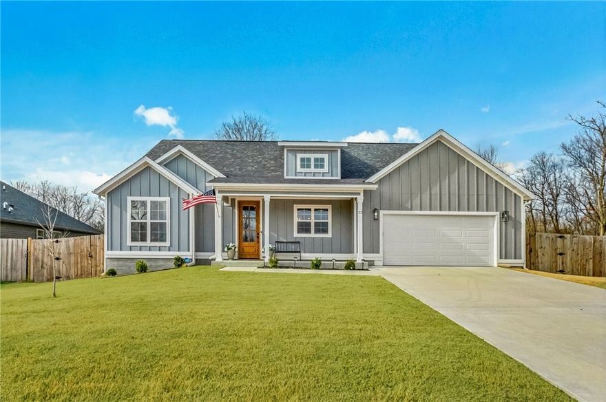 Situated perfectly on a rare FLAT double lot totaling over half an acre, this two year old home feels like a peaceful retreat while still enjoying the convenience of surrounding amenities. Walk through the front door to find a plethora of upgrades. Quartz countertops frame an inviting kitchen with a gas range, walk in pantry and a charming window above the sink overlooking the front porch. Vaulted ceilings lift the open living space anchored by a stunning floor to ceiling gas fireplace, while engineered wood flooring carries through the main areas and the serene primary suite. The spa like bathroom features a soaking tub, walk in shower, his and her vanities and spacious closet. With four bedrooms, 2 bathrooms, a fully fenced yard, a laundry room with its own sink and an abundance of natural light, every corner feels thoughtful and comforting. All just minutes from I49 and a stone's throw from Hole 14 at the Highlands Golf Course, Branchwood Community Center, scenic trails, Lake Loch Lomond and more. Welcome home!!