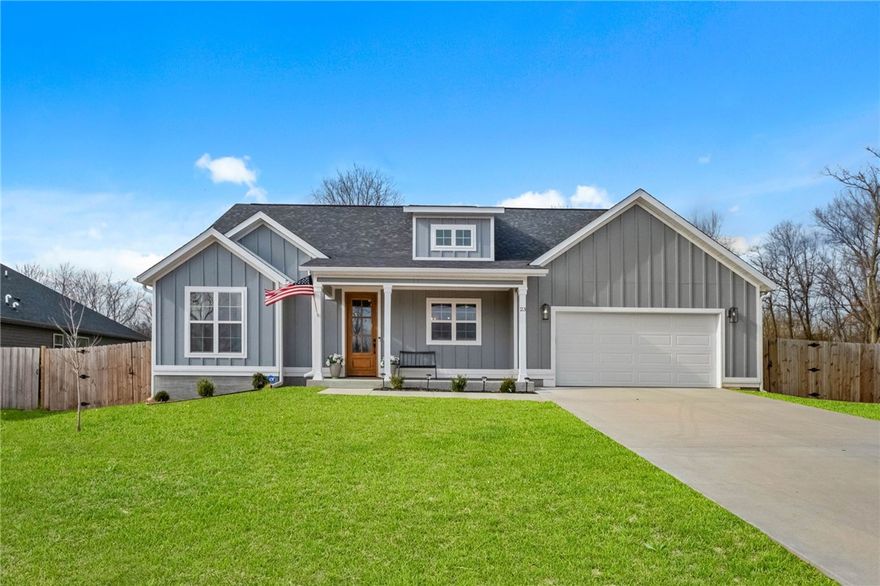 Situated perfectly on a rare FLAT double lot totaling over half an acre, this two year old home feels like a peaceful retreat while still enjoying the convenience of surrounding amenities. Walk through the front door to find a plethora of upgrades. Quartz countertops frame an inviting kitchen with a gas range, walk in pantry and a charming window above the sink overlooking the front porch. Vaulted ceilings lift the open living space anchored by a stunning floor to ceiling gas fireplace, while engineered wood flooring carries through the main areas and the serene primary suite. The spa like bathroom features a soaking tub, walk in shower, his and her vanities and spacious closet. With four bedrooms, 2 bathrooms, a fully fenced yard, a laundry room with its own sink and an abundance of natural light, every corner feels thoughtful and comforting. All just minutes from I49 and a stone's throw from Hole 14 at the Highlands Golf Course, Branchwood Community Center, scenic trails, Lake Loch Lomond and more. Welcome home!!