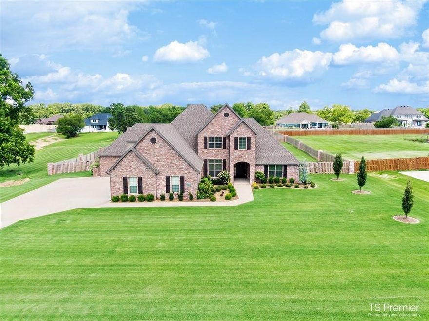 This home has everything you are looking for 5 Bedrooms 5.5 Baths 2 living Areas plus a Bonus Room. The Kitchen is complete with Double Oven,Gas Cook Top, Built in Full size Refrigerator/Freezer. The Master suite is ready for large furniture and the Huge Master Closet ties into the Laundry room. There are 2 Bedrooms on the main floor both with full baths, Upstairs your will find a 2nd Master, Bedroom and a Bonus room with wet bar. There is a 4 car Garage that is large enough for Full Size Trucks and SUV's. There is a covered patio with built in grill over looking a huge fenced back yard with even more room behind the fence on this 1.32 acre lot that can be used. This home looks like day it was built.