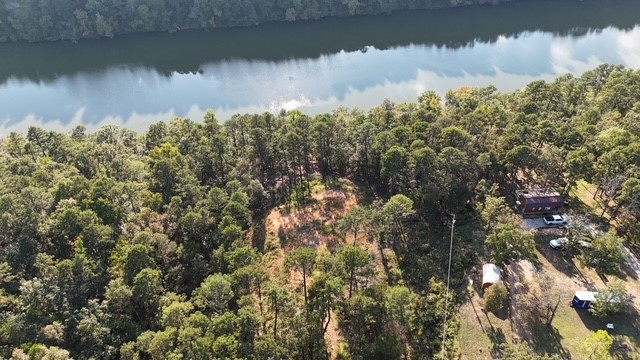 Build your dream home above the Big Piney! This stunning hilltop property offers breathtaking views with creek frontage below. The hard work is done: 100x75 ft pad cleared & built up with 50+ loads of fill dirt, water line run to pad, and a permitted 1,200-gallon septic in place. Perc tested for a 2,200 sq ft home, with public water and electric at the street. A rare opportunity to create your perfect getaway in a private, picturesque setting!