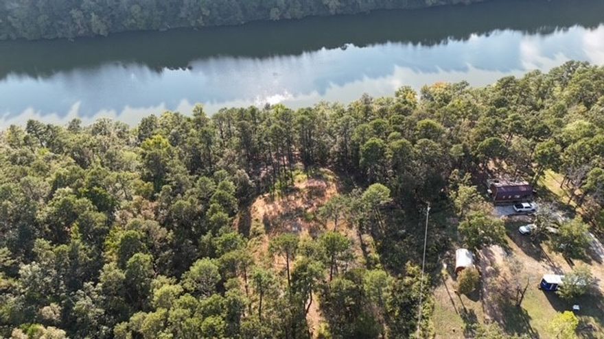 Build your dream home above the Big Piney! This stunning hilltop property offers breathtaking views with creek frontage below. The hard work is done: 100x75 ft pad cleared & built up with 50+ loads of fill dirt, water line run to pad, and a permitted 1,200-gallon septic in place. Perc tested for a 2,200 sq ft home, with public water and electric at the street. A rare opportunity to create your perfect getaway in a private, picturesque setting!