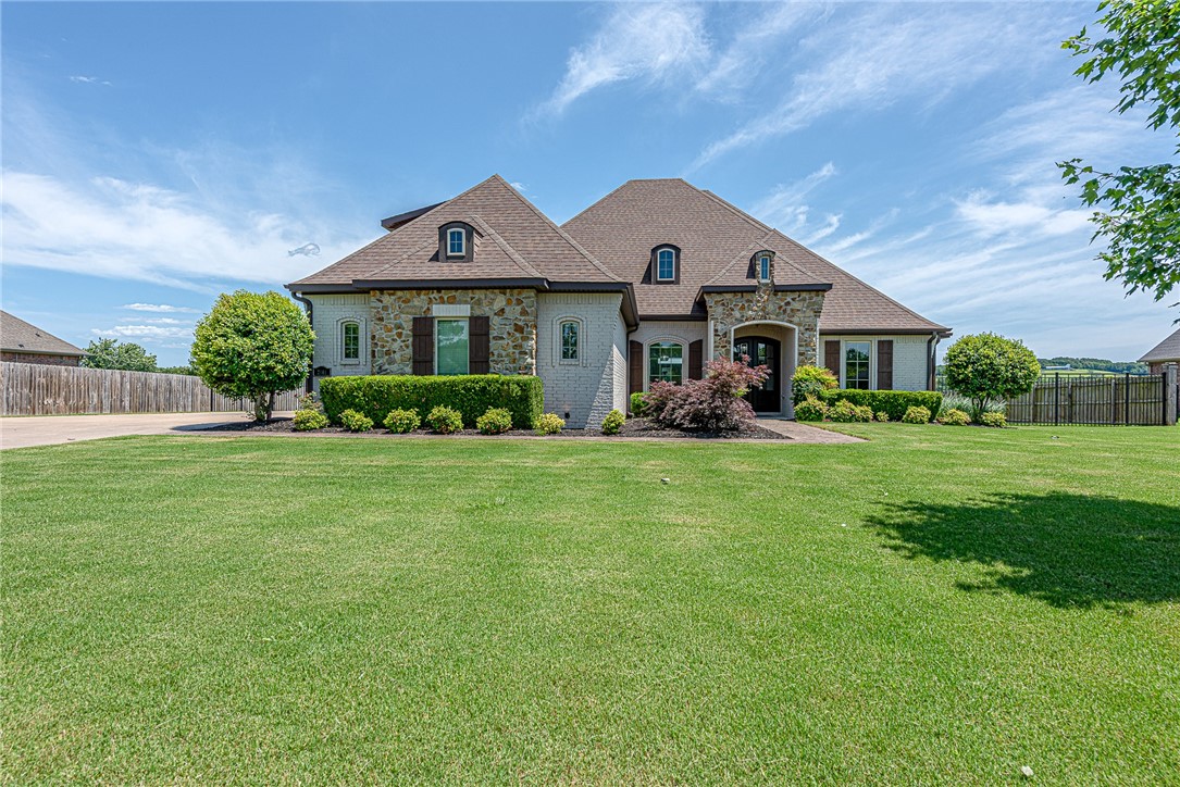 WELCOME HOME! This beautiful 4-bedrm, 2.5-bathrm home in the desirable Waterford Estates offers comfort & elegance in East Fayetteville, min from Crossover & Mission Blvd. From the landscaped walkway, head inside to open-concept built for entertaining. Off the foyer, a private office w/ French doors & coffered ceiling! Formal dining opens to a spacious living w/ hand-scraped wood floors, a stone-accented fireplace, & crown molding. Stunning U-shaped kitchen w/ granite, center island w/ built-in microwave, double oven, & 5-burner cooktop w/ pot filler, & adjoining breakfast nook! Relax in oversized primary suite w/ tray ceiling & ensuite feat: double vanity, walk-in shower, jetted tub, private water closet, & walk-in closet. Two more bedrms on the main flr share a pass-through bathrm. Upstairs, a large fourth bedrm! Outside an expanded back deck w/ outdoor fireplace. Fully fenced backyard offers privacy & storage building! MORE: Low-E windows, wired for security system, & plumbed for central vacuum. Donāt miss out!