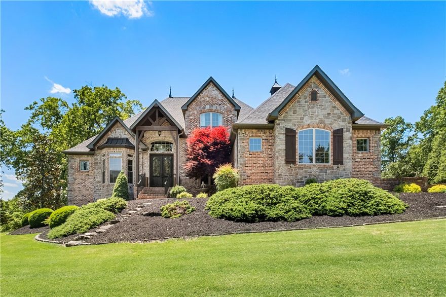 Beautiful Beaver lake home in the gated community of Estates of Lakeway. Includes 2 slips and a lift in the community dock!  This incredible home sits on 2.11 acres with a serene, park-like setting in back and seasonal views of the lake from the front.  Multiple upgrades in recent years include:  New roof, fence, paint, fridge, projector in media room, and many more.  This 4 bedroom, 5 bath home boasts of a large living room with 22 ft. vaulted ceiling with beams and a floor to ceiling stone fireplace.  It has a spacious, eat-in kitchen with granite counter-tops, stainless appliances, large island, pantry and more.  It has an office with a walk-in closet, a large master suite and a guest room with an adjoining bath - all conveniently located on the main level.  The second floor has 2 guest rooms with a J&J bath, as well as a huge media room with balcony, wet bar, new projector and a half bath.  Enjoy fun evenings on the back deck with its large covered area and stone fireplace.  This home is a must see!