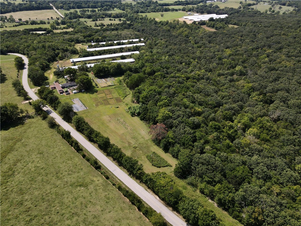 Situated on a beautiful rural parcel, this versatile property offers two homes, three barns/sheds, four former Tyson chicken houses, and approximately an acre of established garden spaceāmaking it ideal for investors, hobby farmers, or anyone looking to build equity with a little elbow grease.
The primary mobile home includes 3 bedrooms and 2 bathrooms, and the second home features 3 bedrooms and 1 bath. Both residences are in need of repairs and updates but offer great potential for multi-family living, rental income, or a live-and-renovate setup.
The four poultry houses were previously leased through Tyson. That lease has now ended, leaving new owners with the flexibility to repurpose the structures for agri-business, storage, or other creative uses. The three outbuildings provide additional space for equipment, tools, or animals.
Love to garden? You'll appreciate the three established gardens, totaling roughly one acre, perfect for growing produce or expanding into a small farmstead.