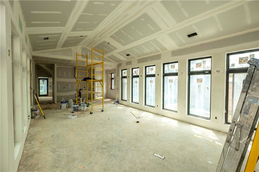 Heart of Bentonville!One of a Kind Contemporary Beauty being built now! In Drywall & Paint stage now! Dazzling Gathering Room=center of home w/Floor to ceiling windows,10 ft ceiling Gathering Room sconces & contemporary lighting!10 ft ceilings throughout downstairs,flush mount ceiling lights most rooms,hardwood floors throughout downstairs and master bedroom,carpet upstairs,gas fireplace,master down,den downstairs,clean lines contemporary,tile in laundry,master bath & 1/2 bath, tile bath upstairs,open living good for entertaining,center room is awesome.expansive master bedroom,huge bath &master closet,lots of light,efficient,work room and extra space in garage,location is awesome,courtyard with mature shade trees,deck,patio in back,granite w/tile backsplash,stand alone tub soaking tub,tile shower with rainshower head,roof metal &architectural shingles,this is a one of kind, 9 ft ceilings upstairs tremendous amount of windows! Ridge skylight over the stairs,In Drywall/paint stage right now!