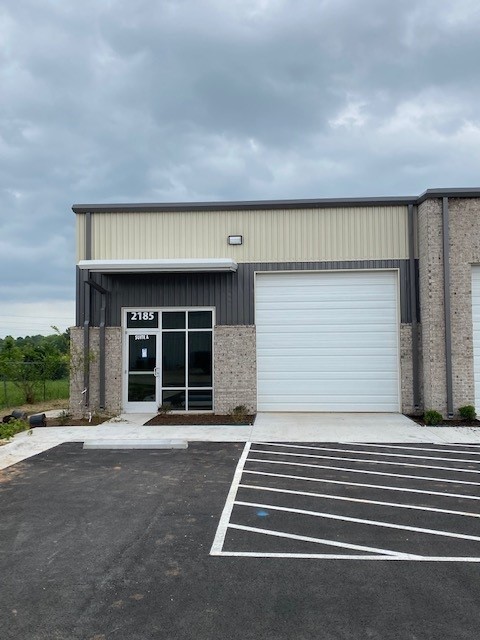 Newly constructed flex warehouse space in the heart of Springdale. Two grade-level 12' roll-up doors with 18' sidewalls and ~ 21' peak height. Rare, fenced yard space in the rear of building for storage and lay down area. It could be gravel or paved depending upon Tenant needs. Tenant has the option to design a small office space and restroom to suit their needs if necessary. This basic Tenant Improvement Allowance is included in the base rent. There could be additional cost for more extensive build-out. That cost is negotiable depending upon the level of finish out and would be added to base rent. This space could also be combined with Suite B (2,100 sf) if it is still available at the time of lease. Additional larger spaces available in the same development beginning in June 2023.