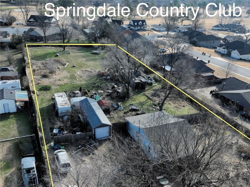 Nearly one-acre prime lot at the end of a quiet street near Business District and Lake Fayetteville. Unique opportunity for builders, investors, or those wanting to custom build with views of Springdale Golf Course. The tranquil setting that used to be a potato field now features established peach trees, plum, blueberry, and blackberry bushes. A privacy fence wraps the majority of the property. Value is in the land and location. The existing home and structures are sold "as-is." Don't miss your chance on this rare find!
