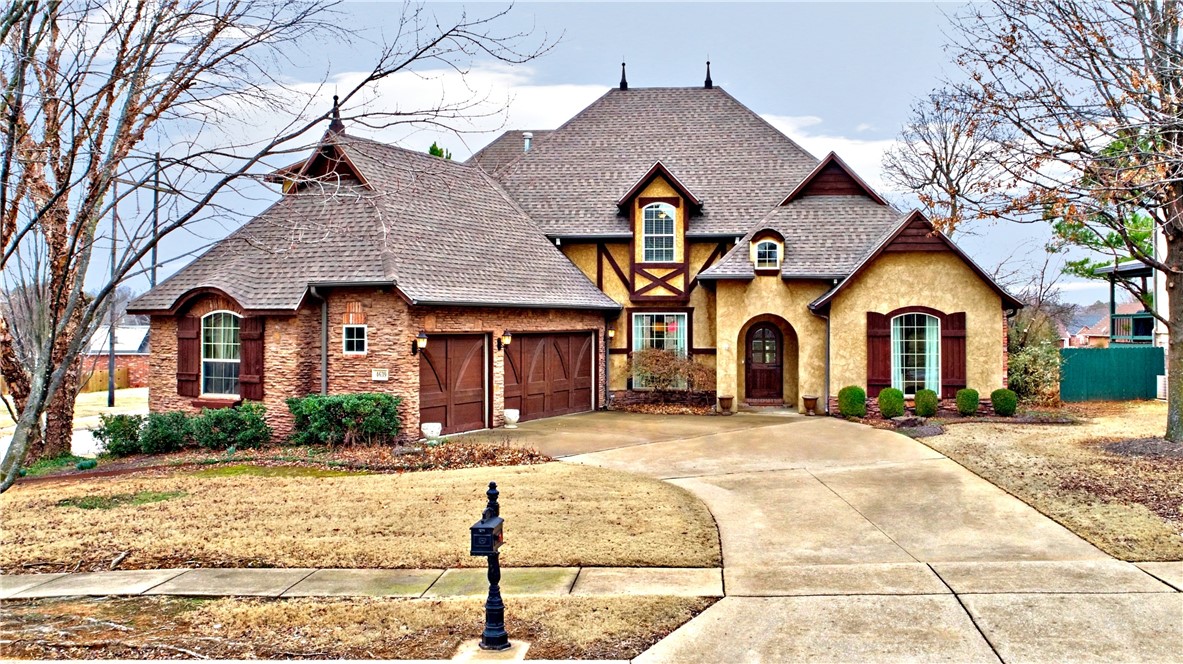 This stunning 3,607 sq. ft. European-inspired home on a corner lot in Copper Creek offers luxury and convenience. Located across from the Botanical Gardens with Razorback Greenway access, it features 4 bedrooms, 3.5 baths, and a 3-car garage. The main level primary suite includes a walk-in shower, Jacuzzi tub, dual vanities, private water closet, and large walk-in closet. The gourmet kitchen boasts dark wood beams, custom cabinetry, granite countertops, a large island, gas cooktop with pasta filler, double oven, and a stucco vent hood, opening to a hearth room with a fireplace. Enjoy a formal dining room, private office, great room with built-ins & gas fireplace, plus a spacious deck overlooking a fenced backyard with a fire pit. Upstairs offers a bedroom suite, two additional bedrooms, a bonus room, and attic stoage. Schedule your tour today!