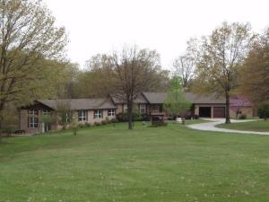 Very nice 4BR 3BA brick home with enclosed pool area with heated pool. Extra large living room with gas fireplace with access to covered deck that also has uncovered area. Open kitchen/dining/living room plus 3 bedrooms on main floor. Family room, bathroom, and 4th bedroom in basement. Family room has gas fireplace. Pool is 18 x 35 with 2 year old liner. Has 5 acre lot, 24 x 40 workshop and 22 x 26 RV shed. Tons of storage. Home and pool is covered by a home warranty with coverage for new buyer.