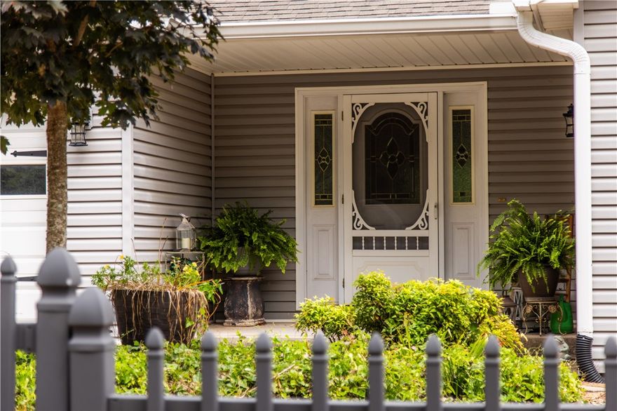 Tucked away on a corner lot, this one-of-a-kind residence blends warmth, charm, and privacy in a storybook setting. Surrounded by a classic picket fence, the serene yard invites you in with its timeless appeal and peaceful atmosphere. Inside, you'll find 2 bedrooms, a light-filled sunroom, dedicated office, and a spiral staircase that leads down to a walkout basement with a spacious bonus room and attached workshop—ideal for hobbies, hosting, or reimagining to suit your vision. Cozy fireplaces in both the living room and the primary suite add a sense of comfort, while bay windows and other thoughtful architectural details bring charm to every corner. Enjoy morning coffee or evening sunsets from two side decks, each with retractable awnings for year-round enjoyment. An oversized backyard shed provides additional room for creativity or storage. With unique spaces and endless possibilities to make it your own, this home is a true gem in Bella Vista.