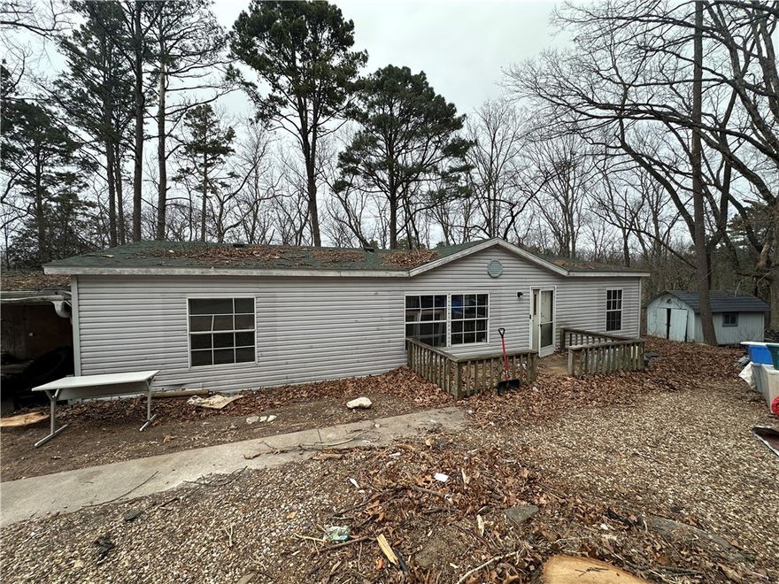 Investor Special! This Double Wide Manufactured Home was new in 1989 and has 3 bedrooms and 2 full bathrooms and a 8x13 Sunroom. The seller purchased this two years ago will full intentions to remodel it, but plans have changed. The entire interior has been gutted down to the subfloor, which all seem to be in good shape expect one small area near the water heater. There is a newer furnace inside the home to replace the original. Some electrical work will be needed and plumbing seems to be intact. The roof was replaced in 2023, but there are some areas on the interior that need repaired from a roof leak prior to the new roof.  Two storage sheds on site and an attached carport! Only 1 mile from the Back 40 Trailhead at Blowing Springs Park! Sold AS-IS!