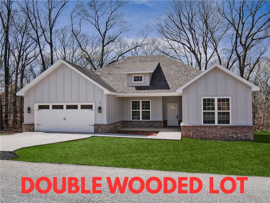 Stunning new construction home on a wooded .52 acre double lot with easy access to I-49! Perfectly situated just minutes from Lake Loch Lomond. Step inside to discover a beautifully designed interior with 3BD's + office, a split floor plan, & custom modern finishes throughout. Wood floors! The spacious living area showcases a beamed vaulted ceiling, creating an inviting atmosphere. The kitchen features sleek 3 cm quartz countertops, a gas range, custom cabinets, and stylish stainless-steel appliances. Retreat to the luxurious primary bath, which boasts a huge walk-in closet, a large custom walk-in tile shower, and a soaking tub. 2 covered patios. As an added bonus, receive $3,500 towards buyer's closing costs when working with the builder’s preferred local lender!